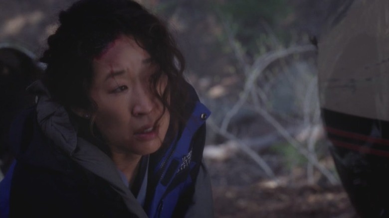Sandra Oh as Dr. Cristina Yang walking through the woods with bruises on her head on Grey's Anatomy