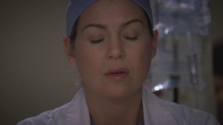 Ellen Pompeo as Dr. Meredith Grey with her eyes closed on Grey's Anatomy
