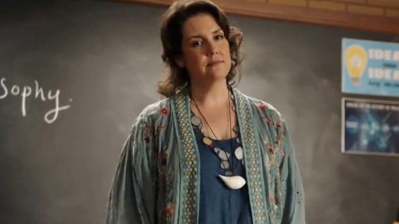 Melanie Lynskey as Professor Dora Ericson stands in front of a chalkboard on Young Sheldon