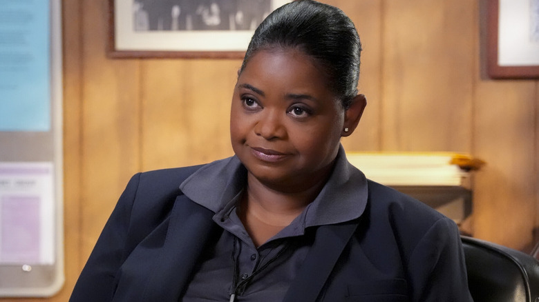 Octavia Spencer as Rhonda Thomason sits at her desk and looks toward the left on Young Sheldon