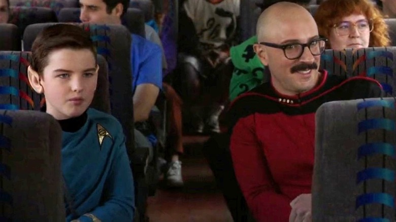 Iain Armitage as Sheldon wears a Spock costume while sitting next to Steve Burns as Nathan on a bus on Young Sheldon