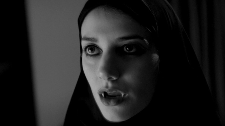 The Girl (Sheila Vand) bearing her fans in A Girl Walks Home Alone at Night