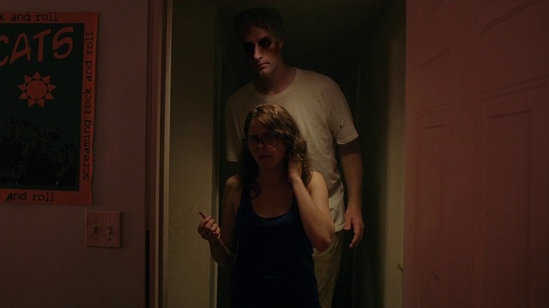 Yara Davis (Olivia Luccardi) standing in front of demon in It Follows
