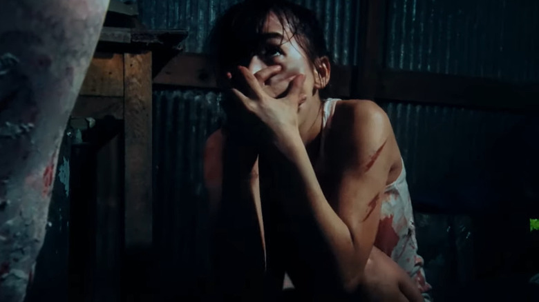 Woman clasping her mouth in One Cut of the Dead