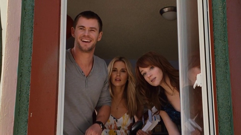 Curt (Chris Hemsworth), Jules (Anna Hutchison), and Dana (Kristen Connolly) looking out a doorway in The Cabin in the Woods