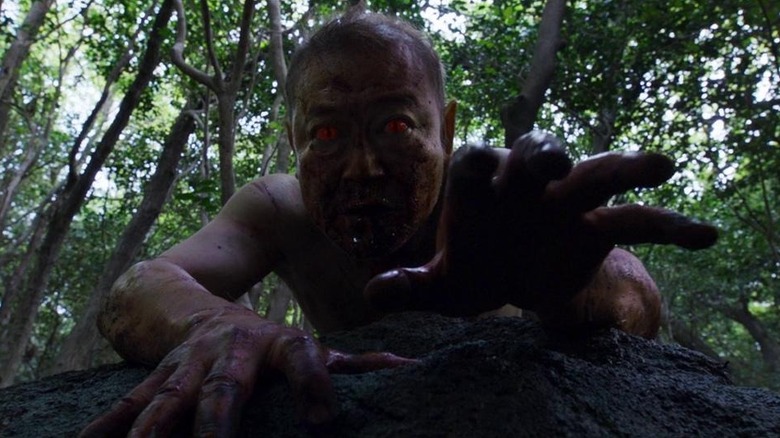 Man with glowing red eyes in The Wailing