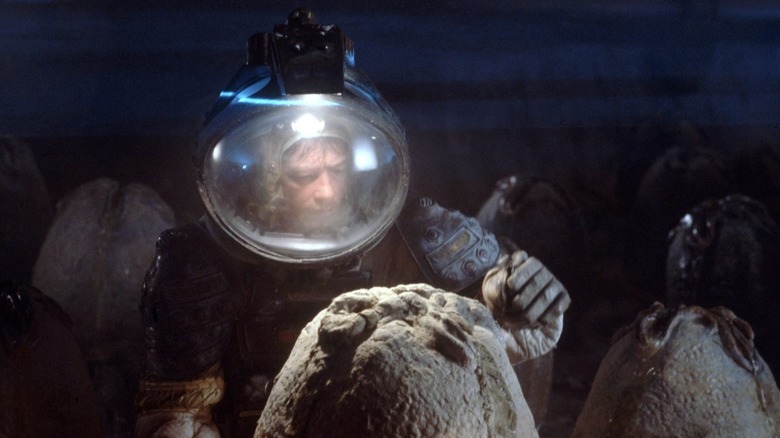 John Hurt as Kane examining an xenomorph egg in Alien