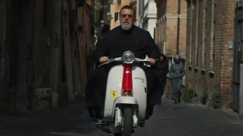 Russell Crowe as Gabriel, zooming on a vespa in The Pope's Exorcist