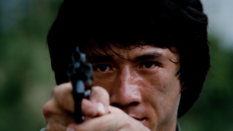 Jackie Chan points gun