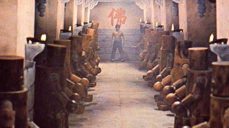 Little Mute (Jackie Chan) enters the hallway of wooden fighters in Shaolin Wooden Men