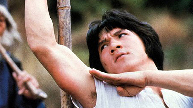 Jackie Chan strains as he trains with a wise master in Snake in the Eagle's Shadow