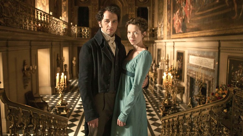 Matthew Rhys and Anna Maxwell Martin in "Death Comes to Pemberley" pose on staircase