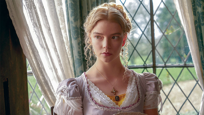 Anya Taylor-Joy in "Emma" sits by window