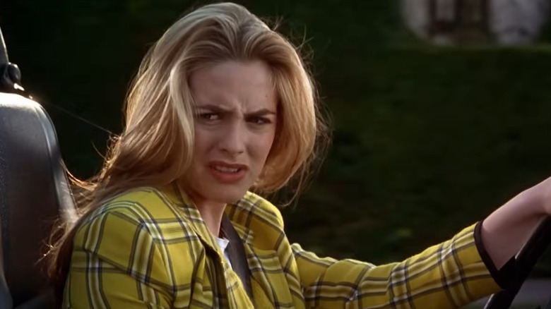 Cher (Alicia Silverstone) glaring while driving in Clueless