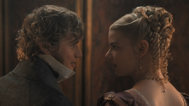 Emma (Anya Taylor-Joy) and Knightley (Johnny Flynn) staring at each other in Emma
