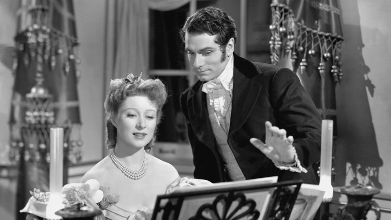 Darcy (Laurence Olivier) watches Elizabeth (Greer Garson) play piano in Pride and Prejudice