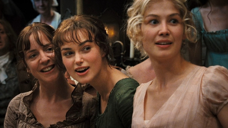 Charlotte (Claudie Blakley), Elizabeth (Keira Knightley), and Jane (Rosamund Pike) excited at ball in Pride and Prejudice