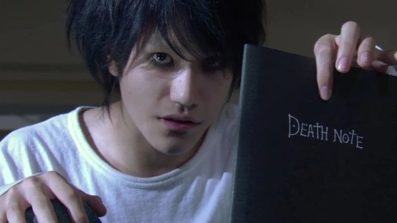 Light holds Death Note