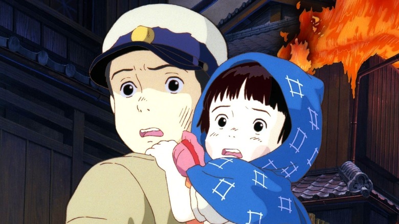 Seita and Setsuko look away in horror from a burning building in Grave of the Fireflies (1988)