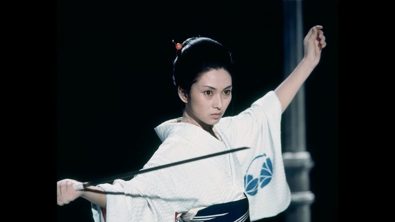 Yuki Kashima (Meiko Kaji) draws her sword in the dark in Lady Snowblood