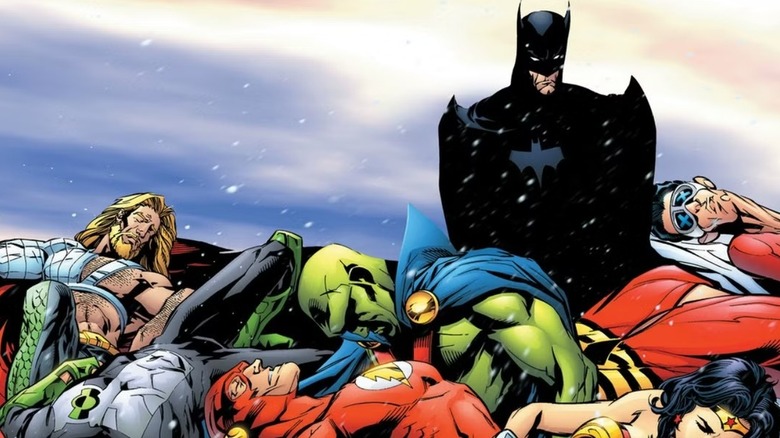 Batman grimly stands over the fallen Justice League on the cover of JLA: Tower of Babel