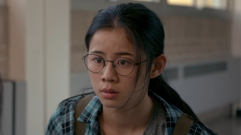 A teenage girl looks at something