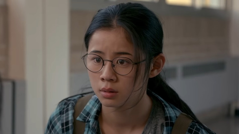 A teenage girl looks at something