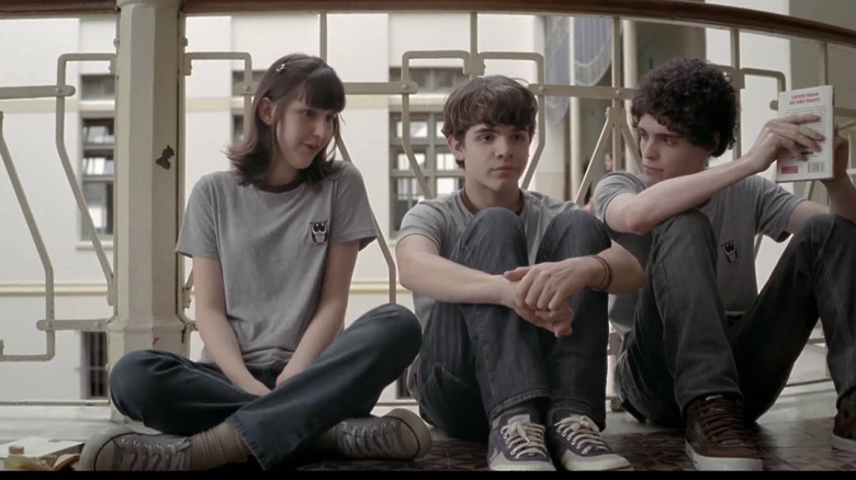 A girl and two boys sit together