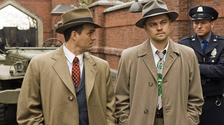 Chuck Aule (Mark Ruffalo) glances at a guard next to Teddy Daniels (Leonardo DiCaprio) in Shutter Island