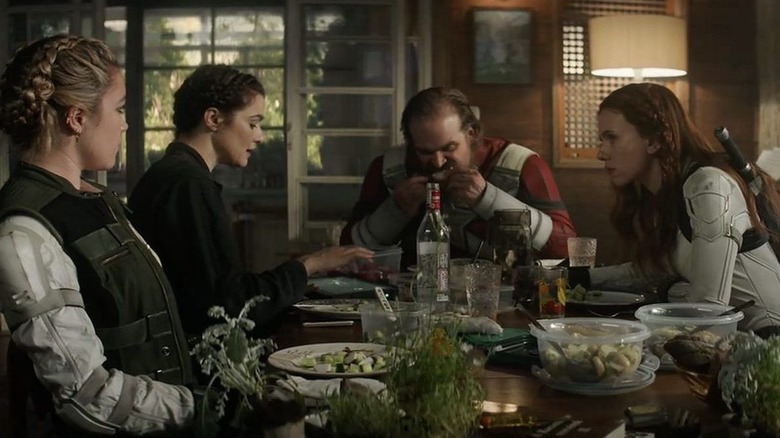 Florence Pugh, Rachel Weisz, David Harbour, and Scarlett Johansson as Yelena, Melina, Alexei, and Natasha having dinner in Black Widow
