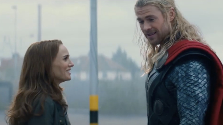Natalie Portman laughing at Chris Hemsworth as Thor in The Dark World