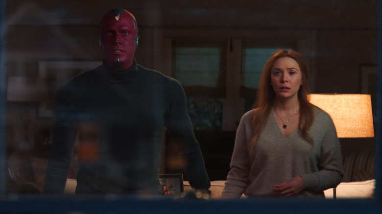 Paul Bettany and Elizabeth Olsen as Vision and Wanda holding hands in WandaVision
