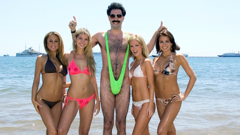 Borat in his electric green bikini with a group of women.
