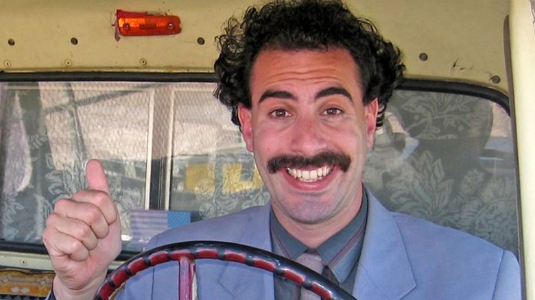 Borat in his electric green bikini with a group of women.
