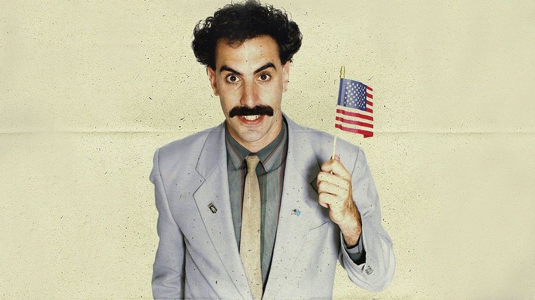 Borat holds a little American flag