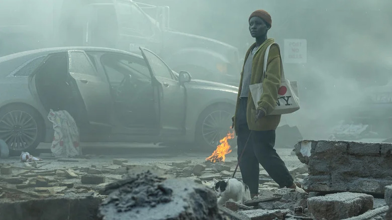 Lupita Nyong'o as Samira, with Frodo the cat, trying to make it through A Quiet Place: Day One