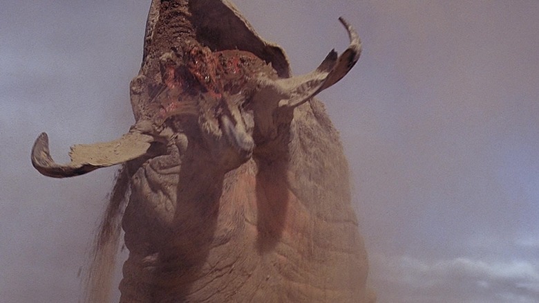 A Graboid bursts out of the sand in Tremors
