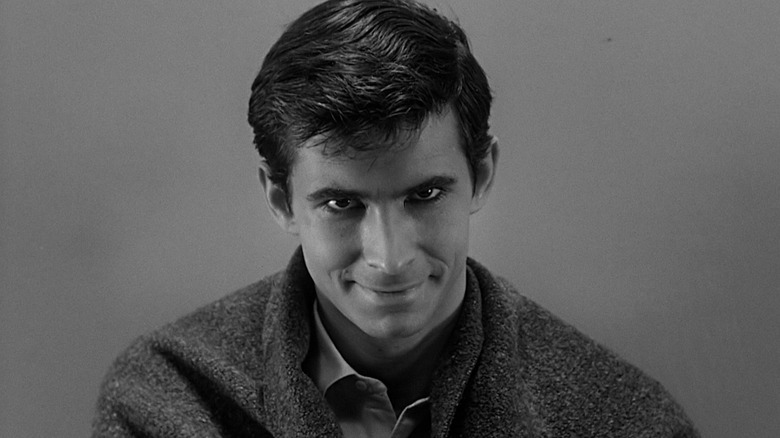 Anthony Perks as Norman Bates, smiling with a blanket wrapped around his shoulders in Psycho (1960)