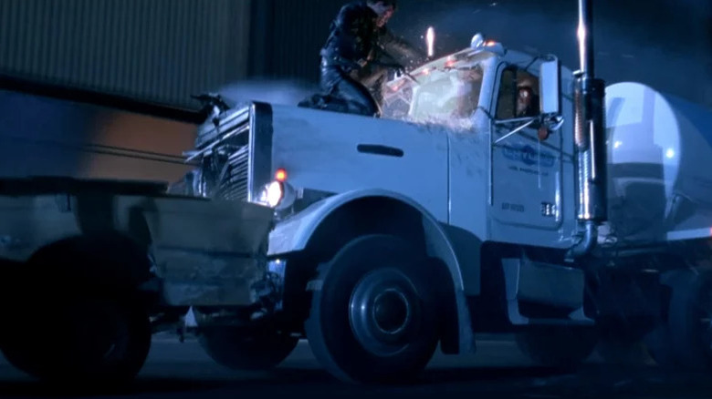 Peter Kent (stunt double for the Terminator) kneeling on the hood of a danker with an automatic rifle in Terminator 2: Judgment Day
