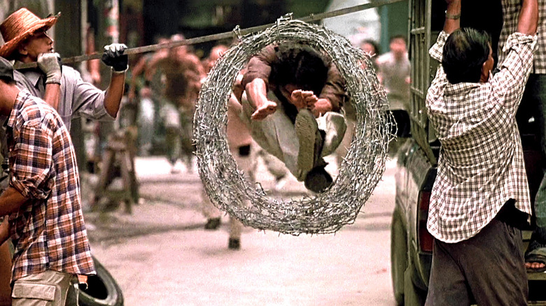 Tony Jaa as TIng leaping through a hoop of barbed wire in the street in Ong-Bak: The Thai Warrior