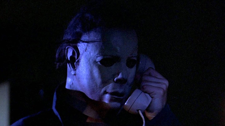 Nick Castle as  Michael Myers holding a telephone in Halloween (1978)
