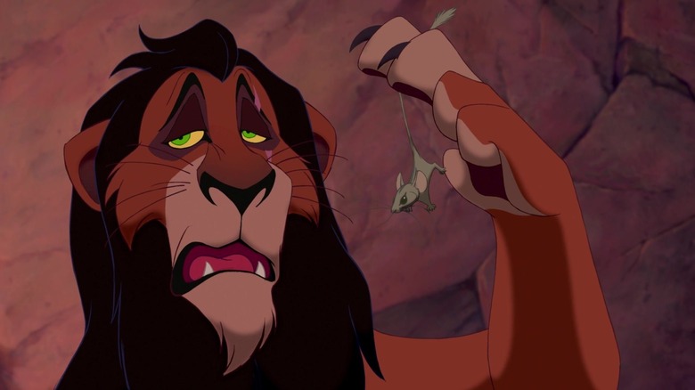 Jeremy Irons' Scar holding a house in his paw in The Lion King