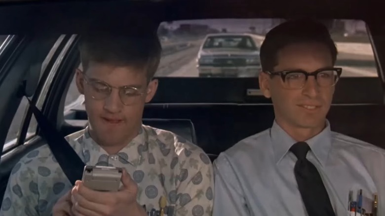 Anthony Edwards as Gilbert, holding his calculator, and Robert Carradine as Lewis, in the car in Revenge of the Nerds