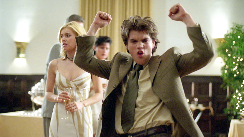 Emile Hirsch as Matthew dancing wildly while Danielle (Elisha Cuthbert) looks concerned behind him in The Girl Next Door