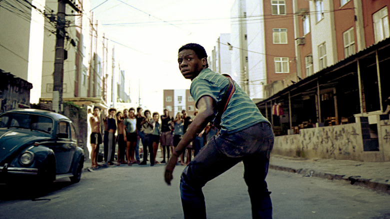 Rocket (Alexandre Rodrigues) looks back while standing in front of a street gang in City of God