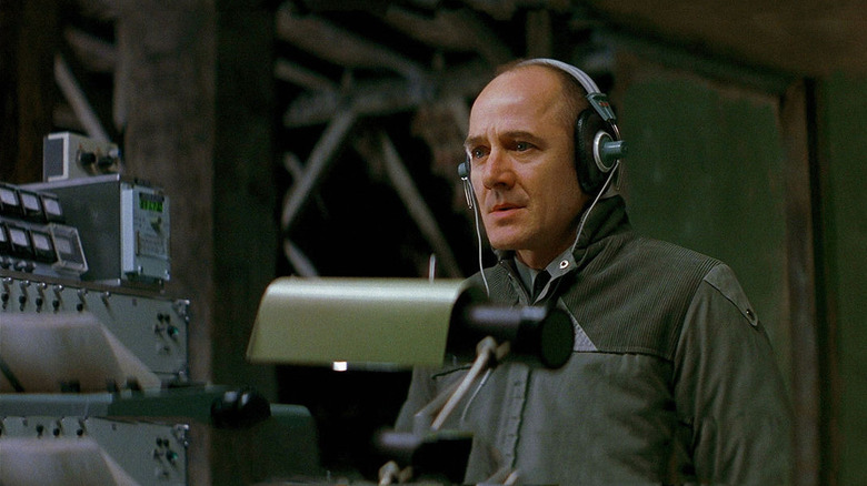Gerd Wiesler (Ulrich Mühe) listens to a wiretap with tears in his eyes in The Lives of Others