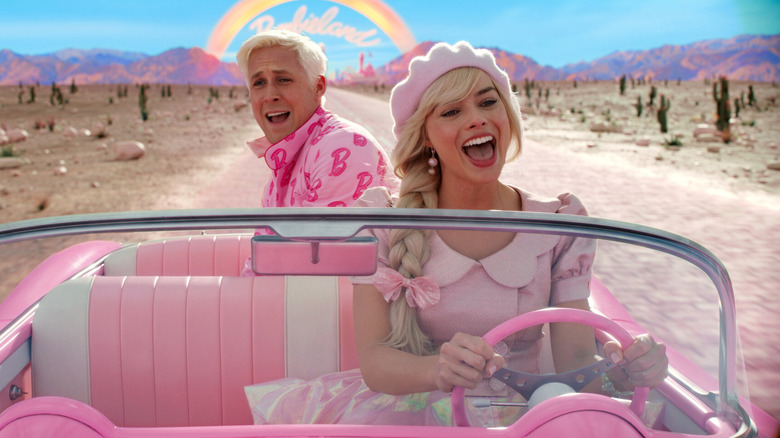 Margot Robbie as Barbie and Ryan Gosling as Ken singing and driving in Barbie's convertible in Barbie