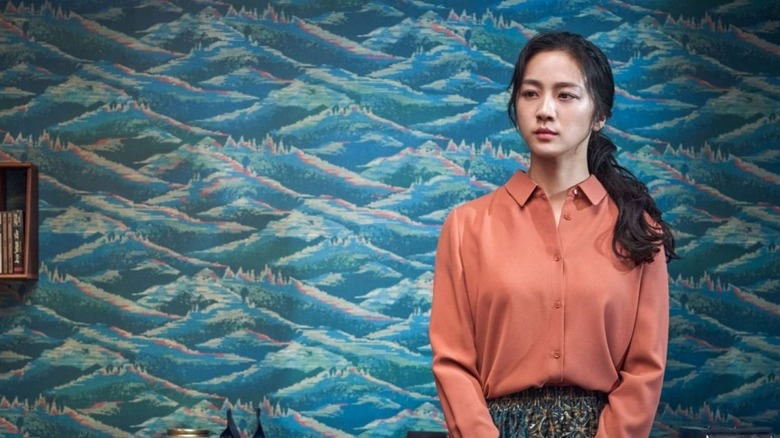 Tang Wei as Song, standing before mountains or waves in Decision to Leave