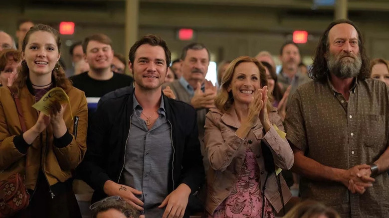 Amy Forsyth as Gertie, Daniel Durant as Leo, Marlee Matlin as Jackie and Troy Kotsur as Frank, all standing and clapping in Coda
