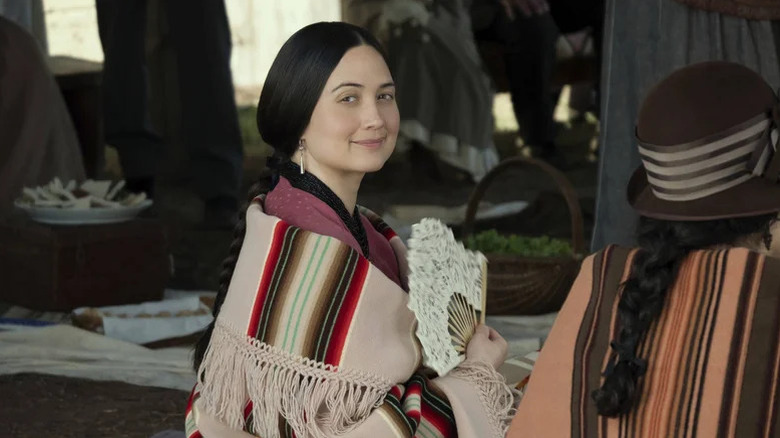 Lily Gladstone as Molly wearing striped blanket and holding fan in Killers of the Moon